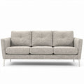 Light gray upholstered three-seater sofa with button details and metal legs
